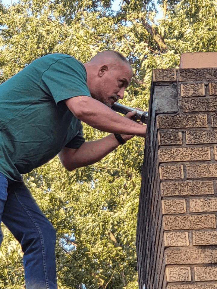 A Photo of Greg inspecting a roof, our Lead Home Inspector Akron OH